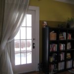 Completed, painted door. Curtain hangs over it during the winter as an extra layer of insulation, and for privacy in evenings during the summer.