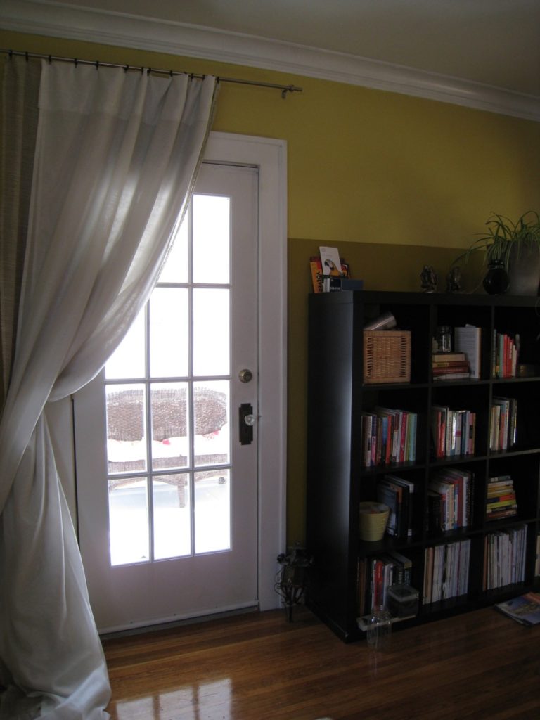 Completed, painted door. Curtain hangs over it during the winter as an extra layer of insulation, and for privacy in evenings during the summer.