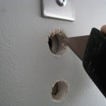 Before patching, I used a razorblade to trim away the "fuzz". I didn't want my wall to appear to have any sign of damage, and I imagined the edges of holes looking "feathered" after patching.