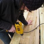 Me, drilling holes in the posts for carriage bolts.  Me, drilling holes in the posts for carriage bolts.