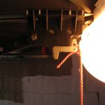 That white tab slanted diagonally at the top is the second tab - the one the top of the door touches to signal when the door has been raised enough.