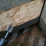 Carving out the inside edge of the frame so that the mirror could sit inside.