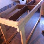 Table upright, starting to put together the bottom shelf.