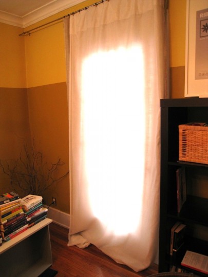 A living room door curtain hung helps insulate when the weather is poor.