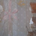 Beautiful hand-painted lace detailing uncovered underneath some of the plaster.
