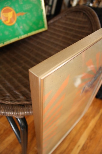 Goldie-brassy frame edge.