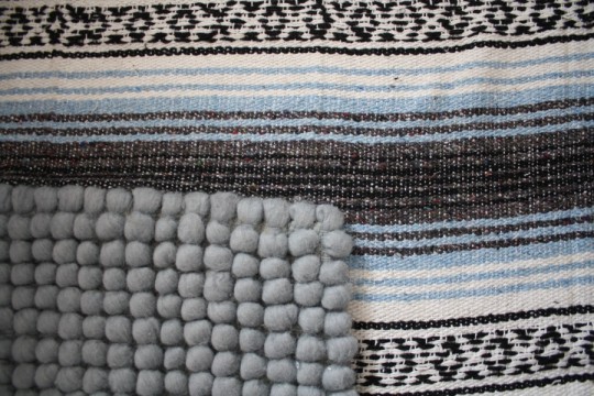 How about a close-up of the overlapping West Elm Pebble Rug and Mexican "rug"? How about a close-up of the overlapping West Elm Pebble Rug and Mexican "rug"?