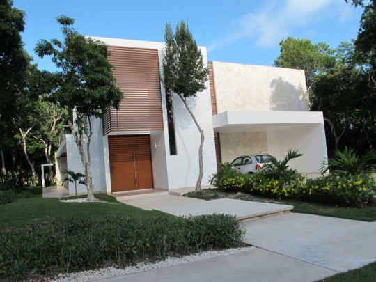 Beautiful, functional home with a sleek garage overhang.
