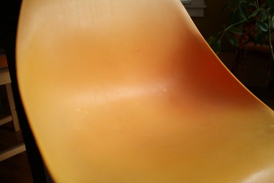 Discolored chair plastic. Light orange to pumpkin orange gradation. That shading you see is not just shadow.