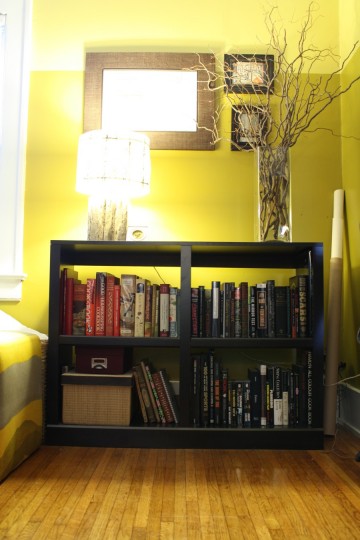 Neutralizing this smaller shelf. Starting to fill it with black-spined books.