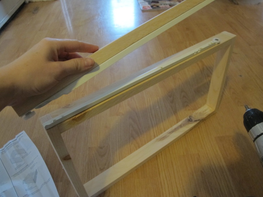 Determining where the drawer sliding track needs to sit to match up to its mate on the wall.