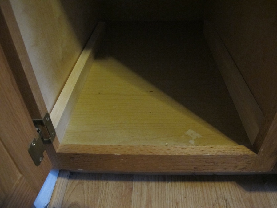 I fit 22" pieces of furring strip along the sides of the cabinet to even out the framing issue.