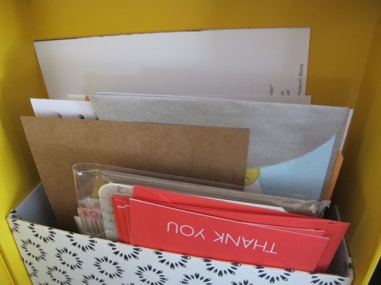 Filling the new folder in the upcycled shoebox.