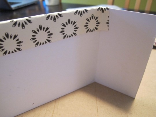 Wrapping the paper around the backside of the mat paper.
