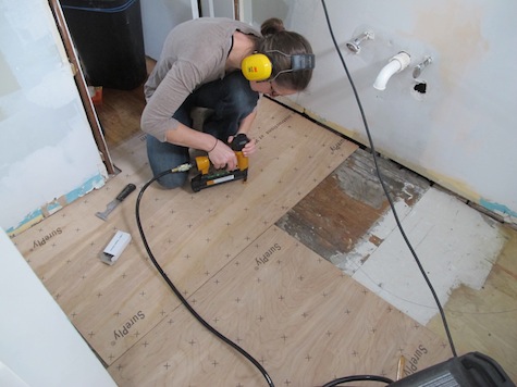 Installing bathroom subfloor.
