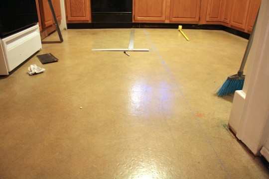 Planning the kitchen floor tile placement.