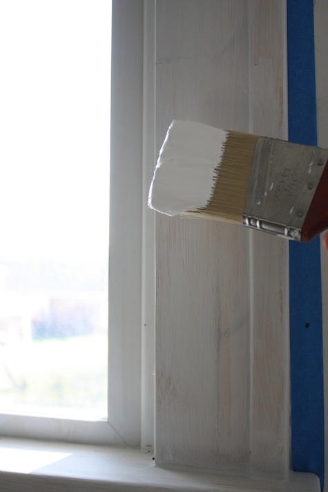 Painting wooden window trim.