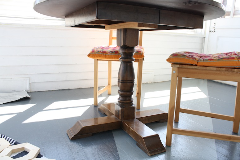 New sunroom table with a wooden pedestal base.