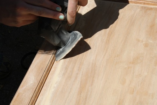 Getting into the angles of the cabinet door with the sanding attachment on the multi-tool.