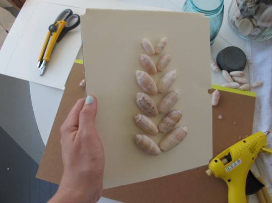 Custom shadow box art using craft paper and seashells