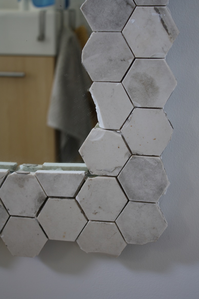 Detail on a mirror frame made using vintage marble hex tiles.