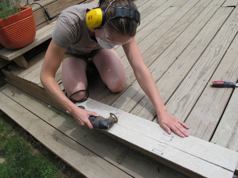 Cutting through cement board with a multitool.