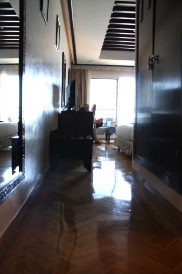 Herringbone tile floors, plaster walls, and lots of sunlight in our hotel room in Morocco.