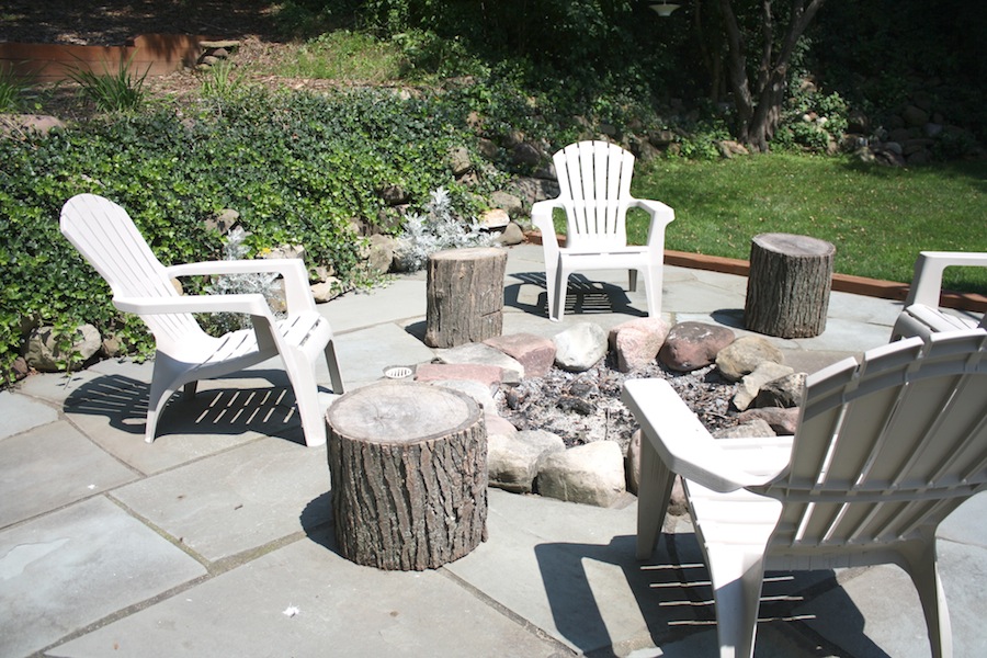 Just beyond the pergola, a built-in fire pit in their flagstone patio.