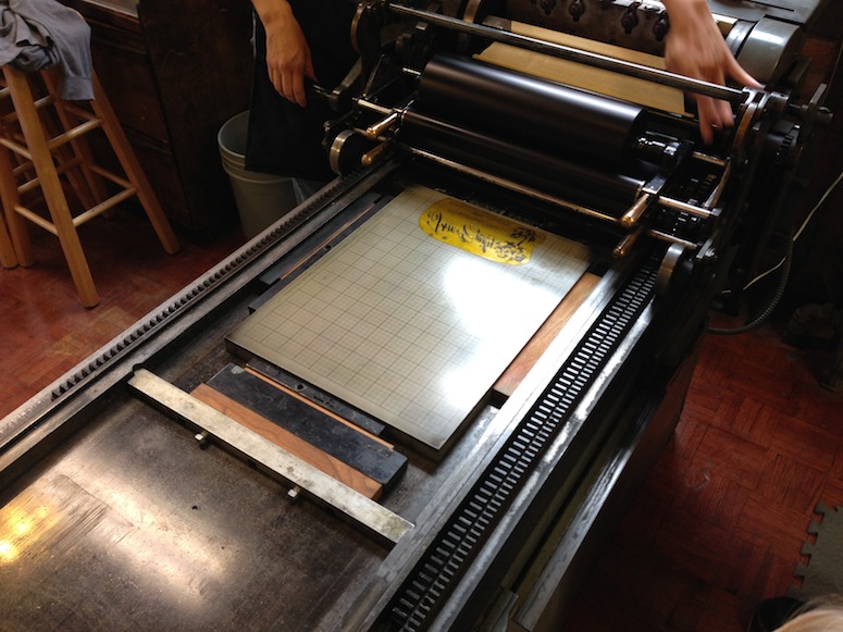 Checking out our custom invite plate on Fly Rabbit Run's letterpress.