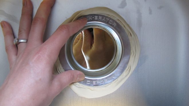 Installing the disposal sink flange.