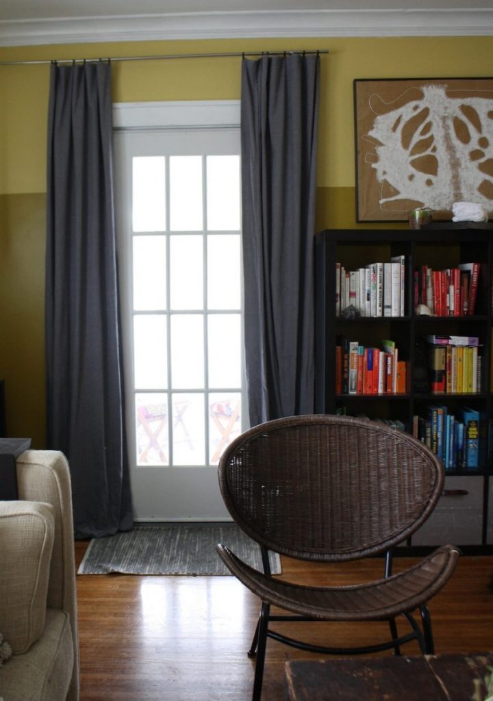 Painter's cloth curtains help insulate over a drafty glass paned door.