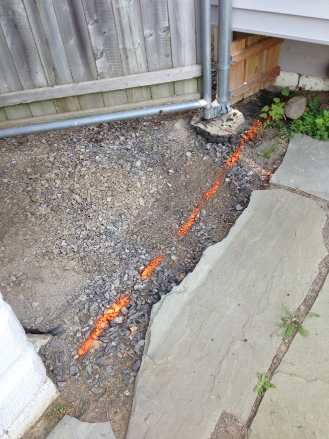 Marking the asphalt borders in the backyard.