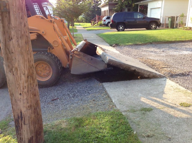 Removing the sidewalk in front of the house.