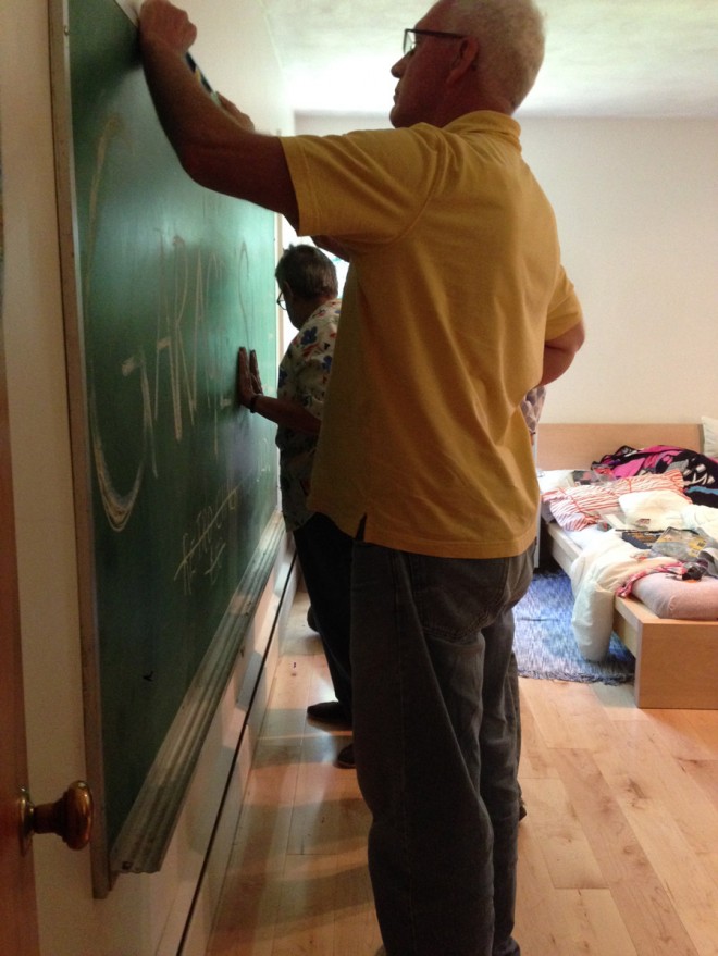 Installing the chalkboard in our kid's room.