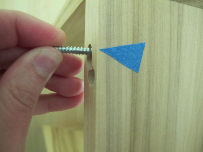 Marking holes to install a shelf that relies on keyholes.