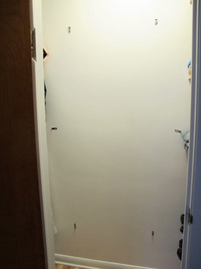 Using toggle bolts to hang a heavy mirror on the wall.