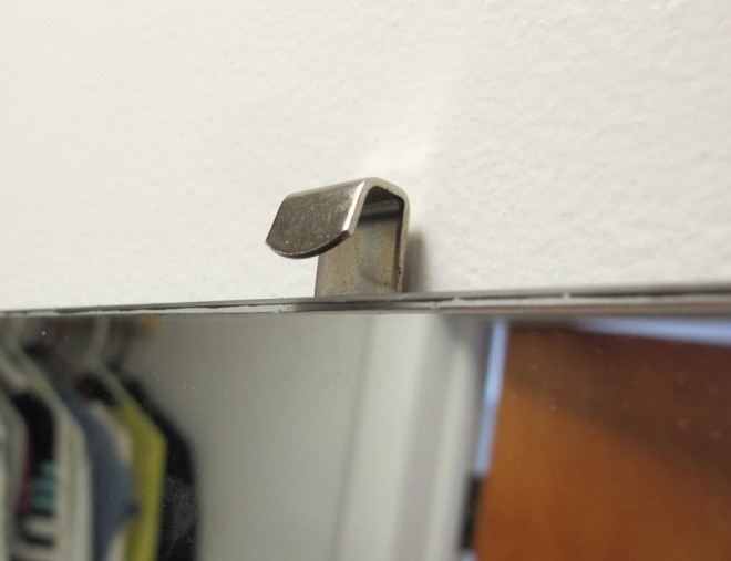 Mirror clips to hold the mirror against the drywall.