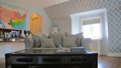 Stenciled wall in a pretty, well-decorated lounge space.