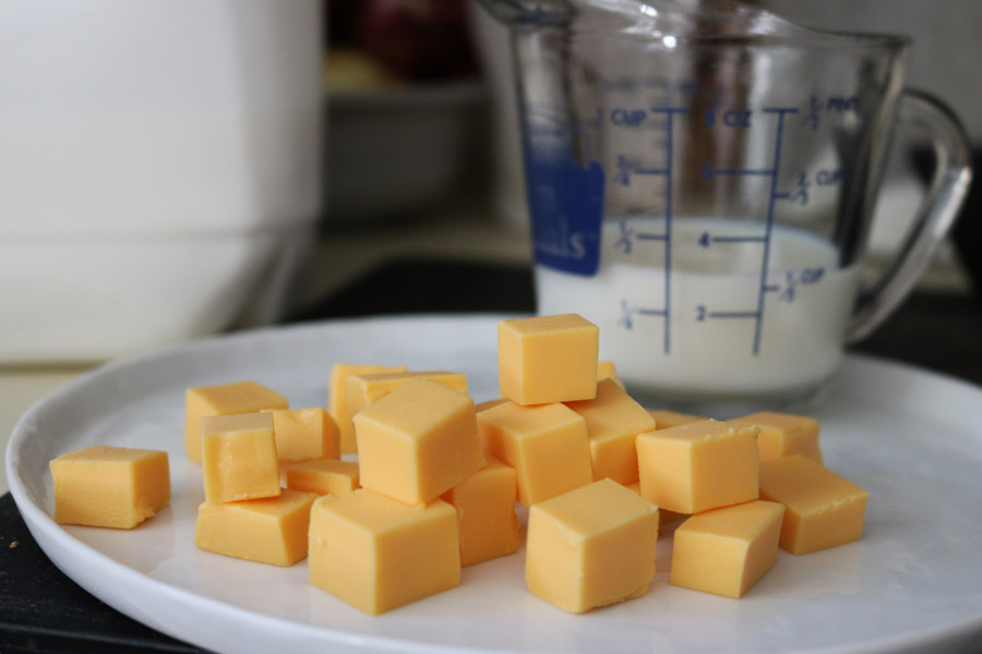 Velveeta cheese and milk for a Halloween pasta recipe.