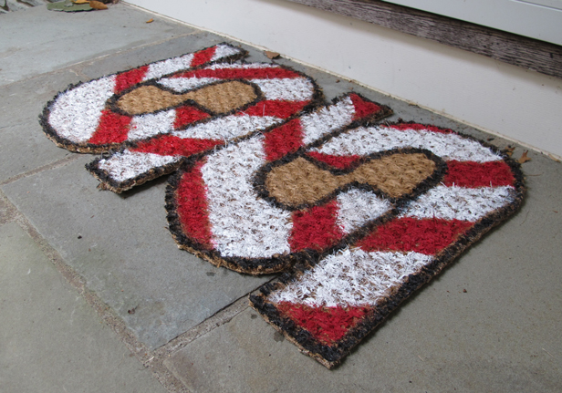 DIY holiday doormat with painted candy canes.