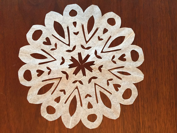 Making snowflakes out of coffee filters.