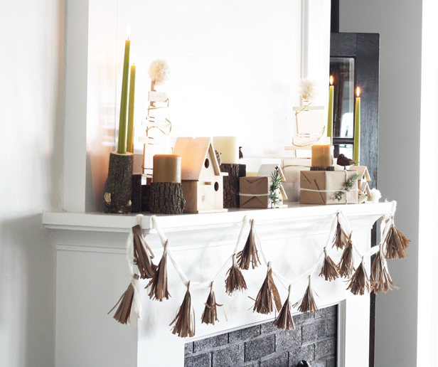 Style a natural, modern holiday mantel for your home using kraft paper, wooden accents, and pine branches.