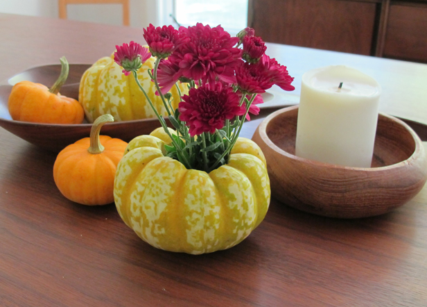 How to make a fall DIY pumpkin planter for mums and other autumn plants.