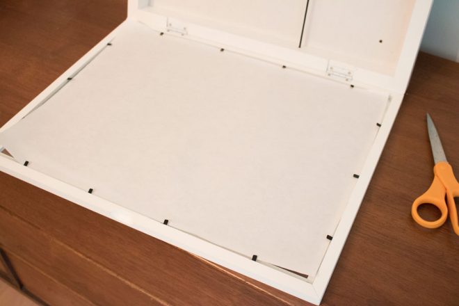 Line the inside of the frame with a piece of paper to make a DIY lightbox.
