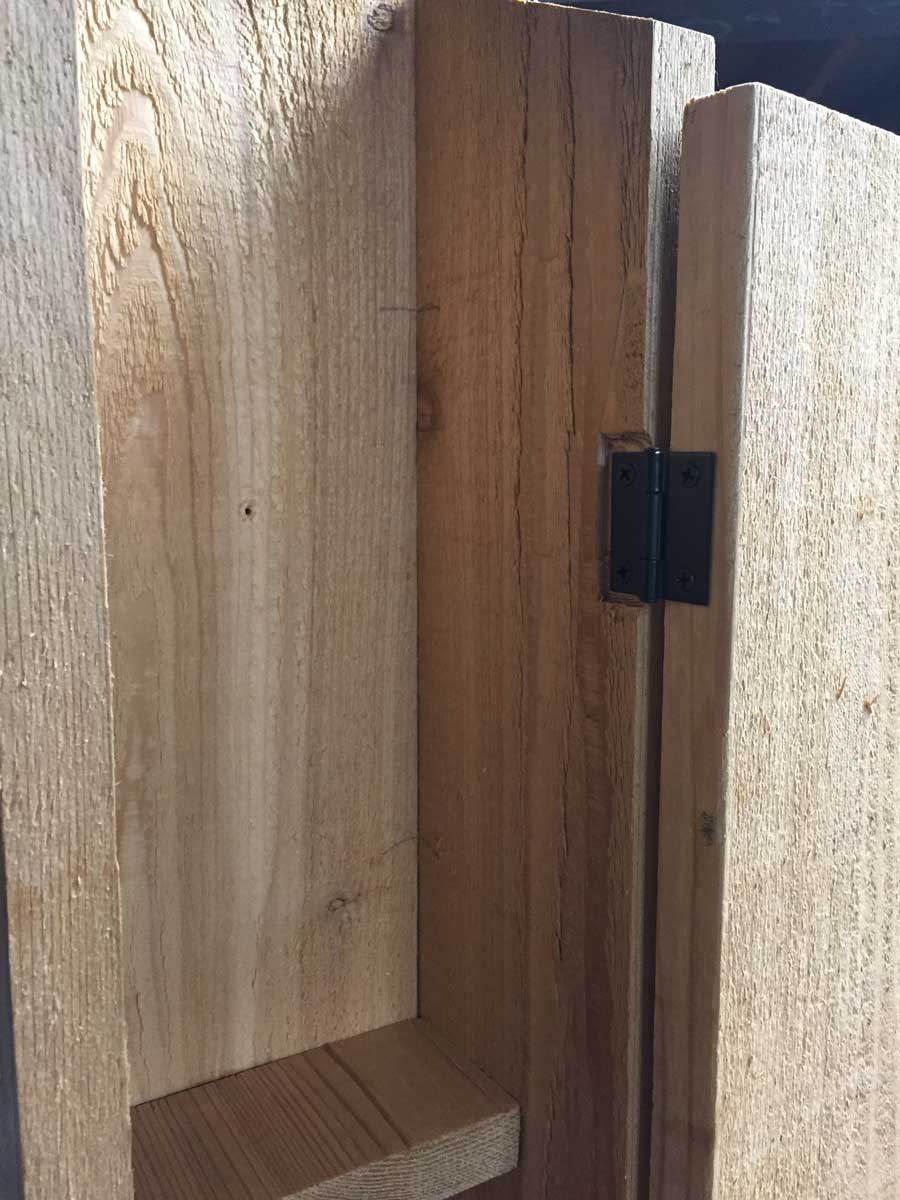 Our DIY garden storage shed made of cedar boards.