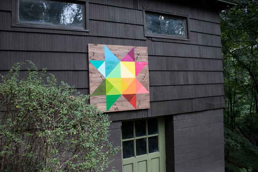 Modern, rainbow-colored barn quilt on our mid-century home's outbuilding.