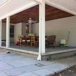 Removing panels of screens on a covered porch to open up an outdoor living space.